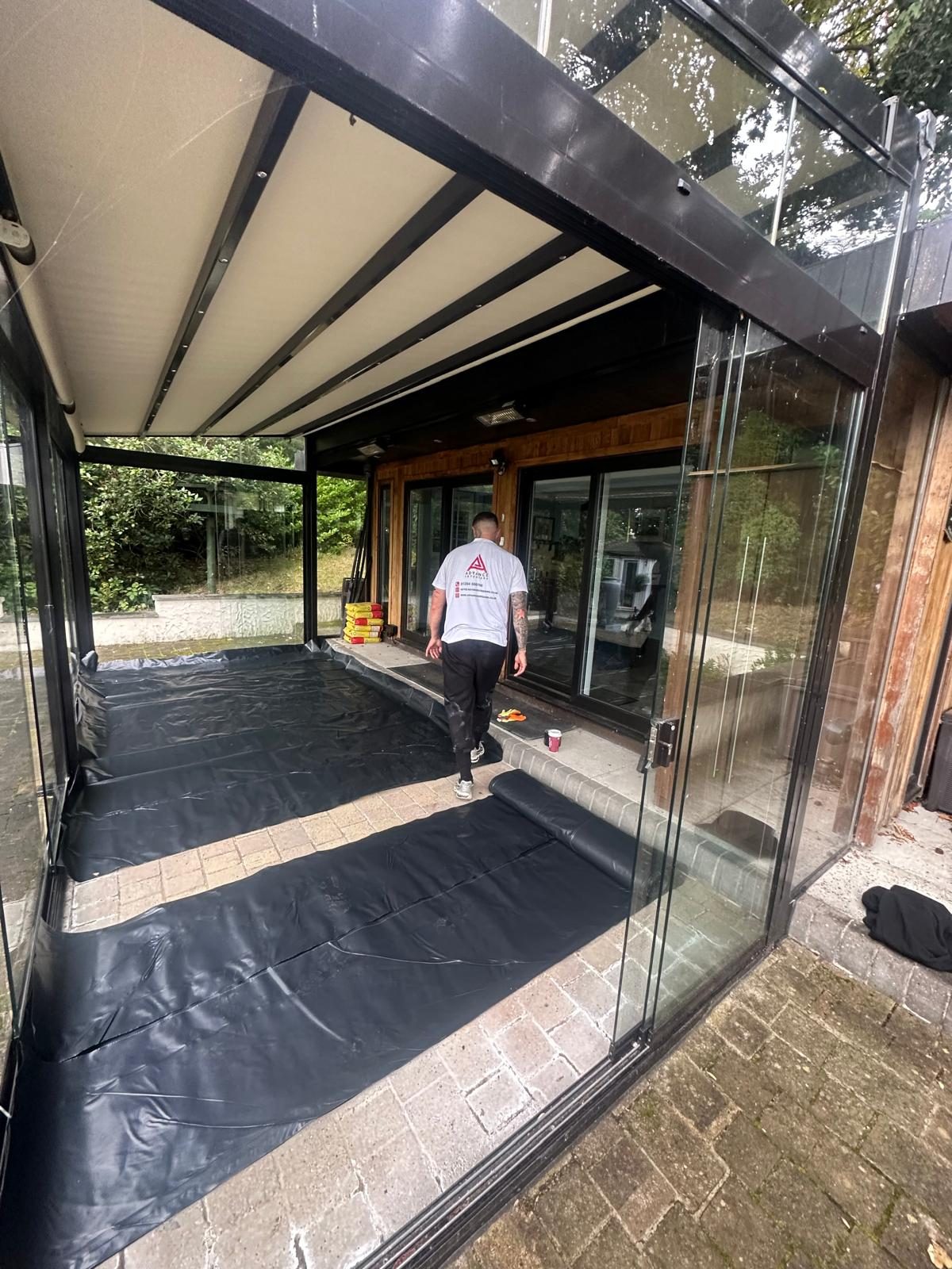 Visqueen membrane laid across the summer room floor and lapped up the perimeter before the screed