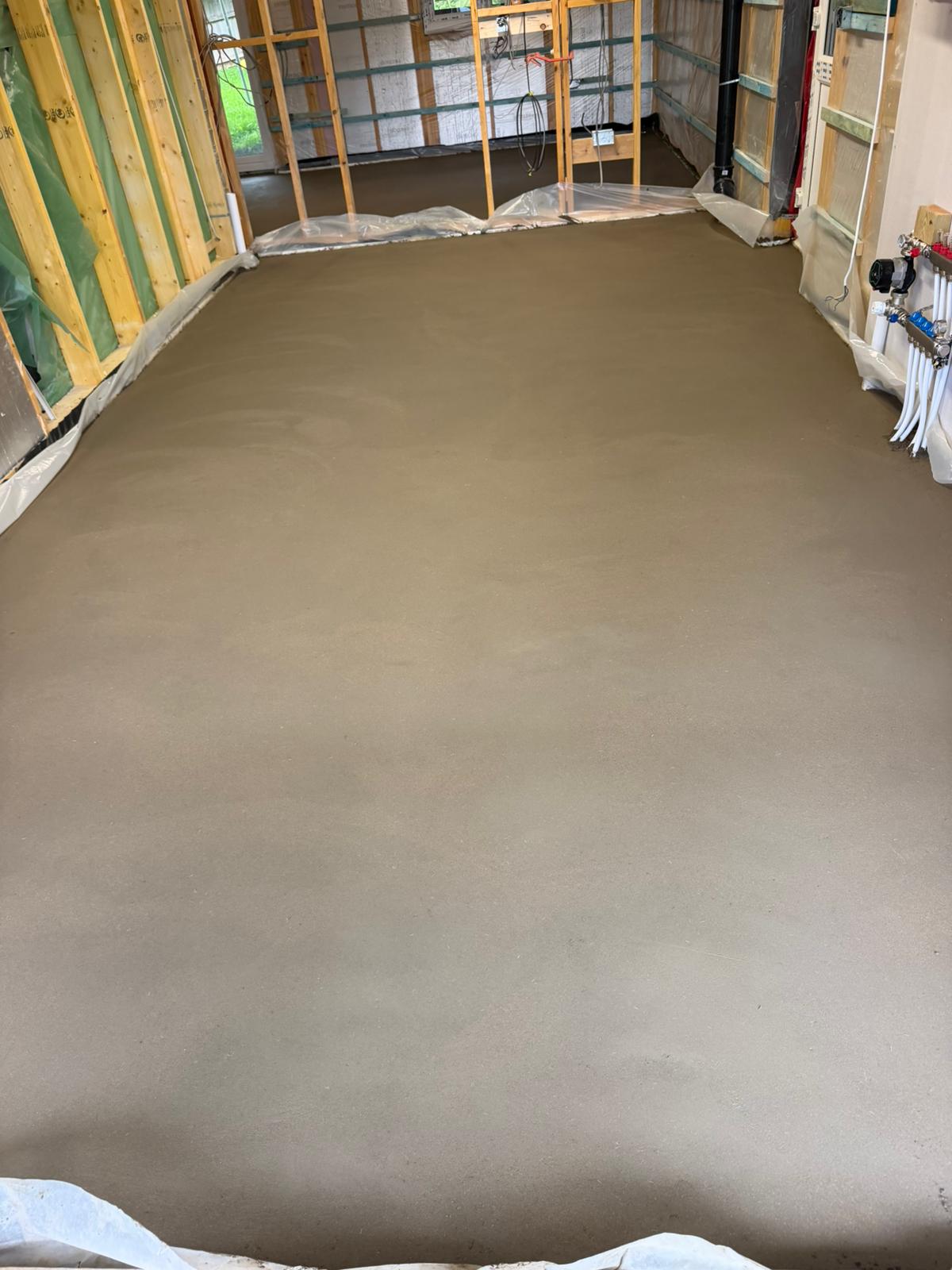 Finished screed run wall to wall through the new build, with the perimeter edge strip in place