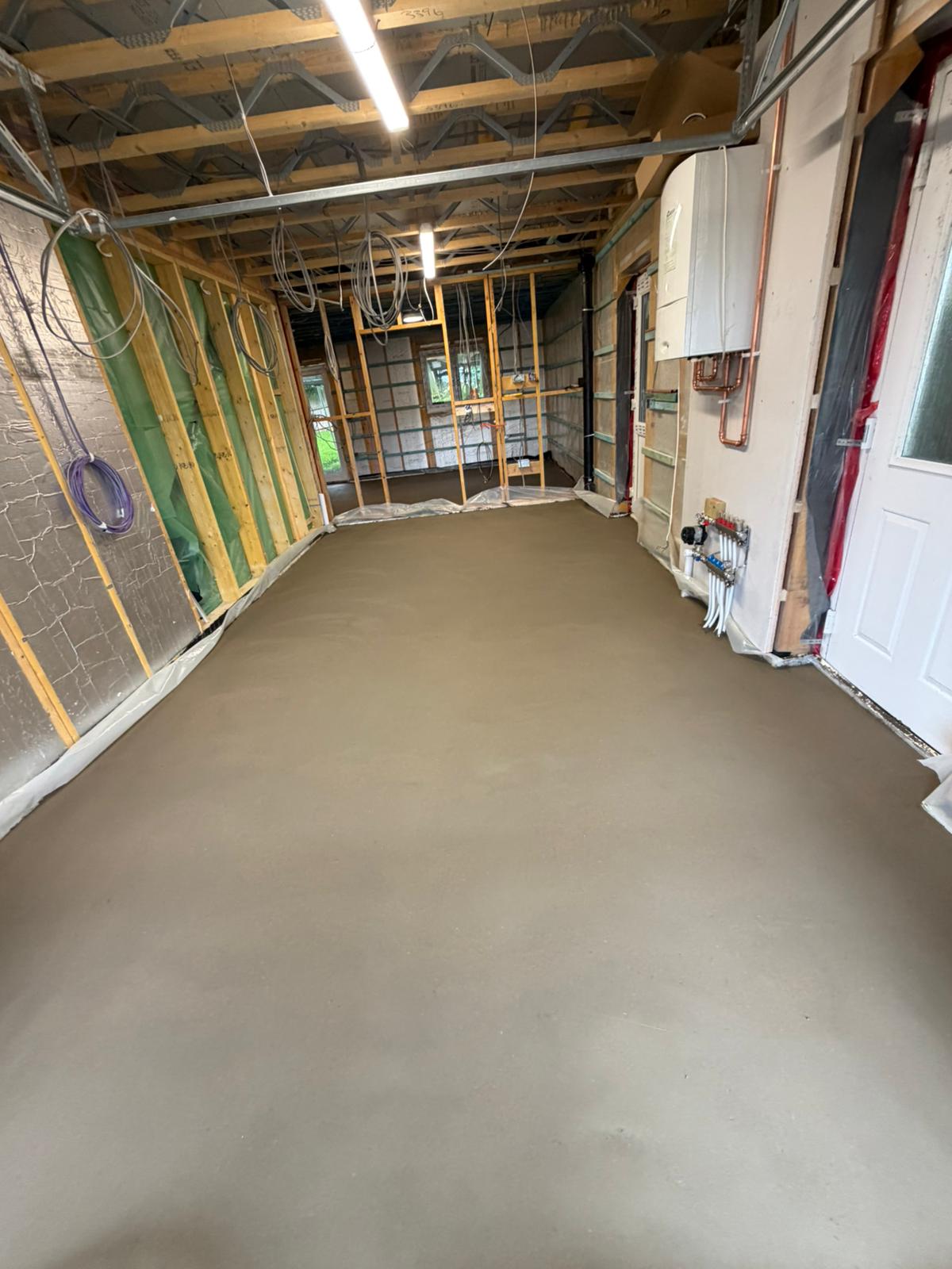 Fibre reinforced screed laid over the underfloor heating across the new build ground floor at Bolton le Sands