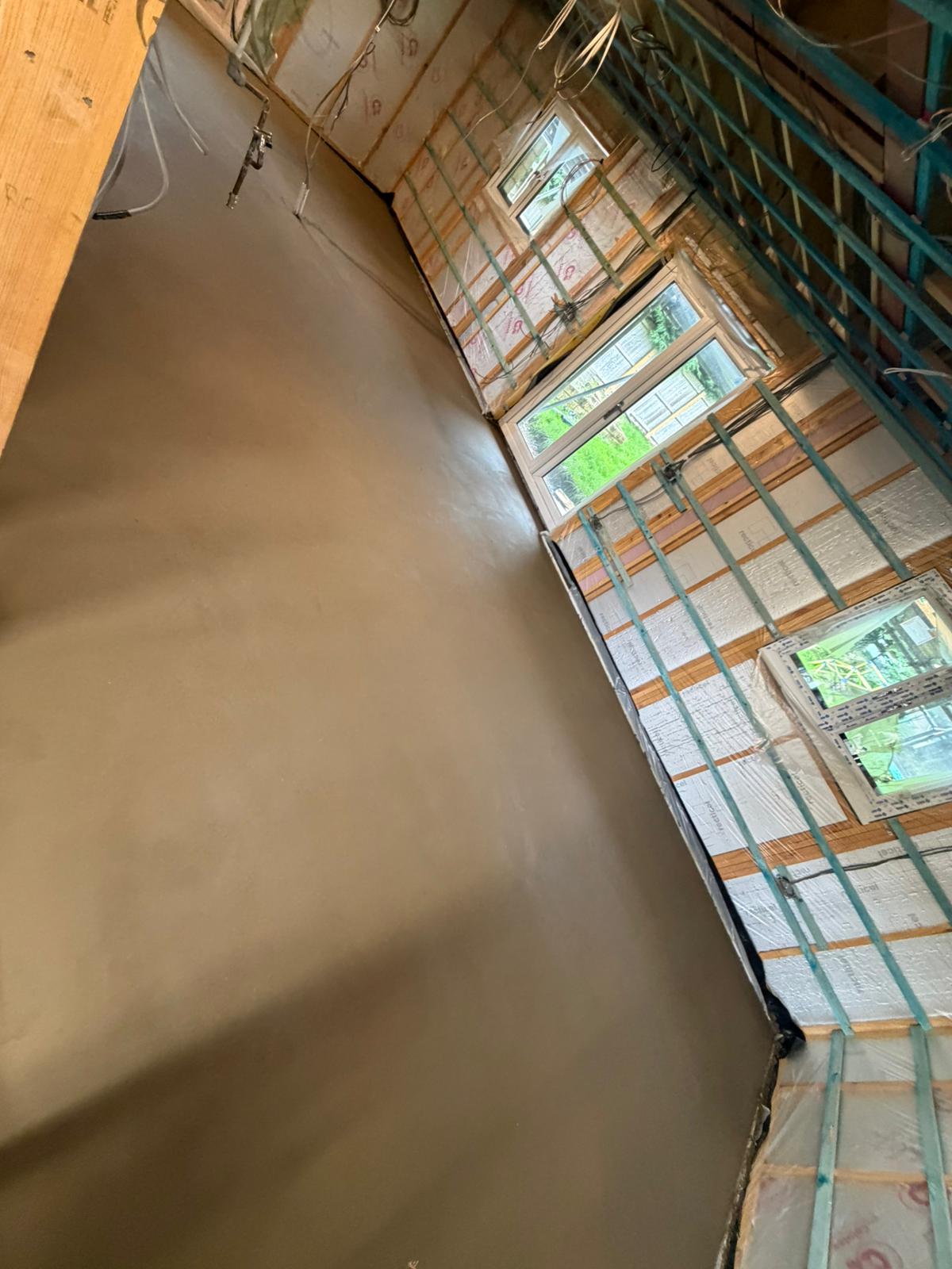 Flat screed finish running along the window wall of the new build