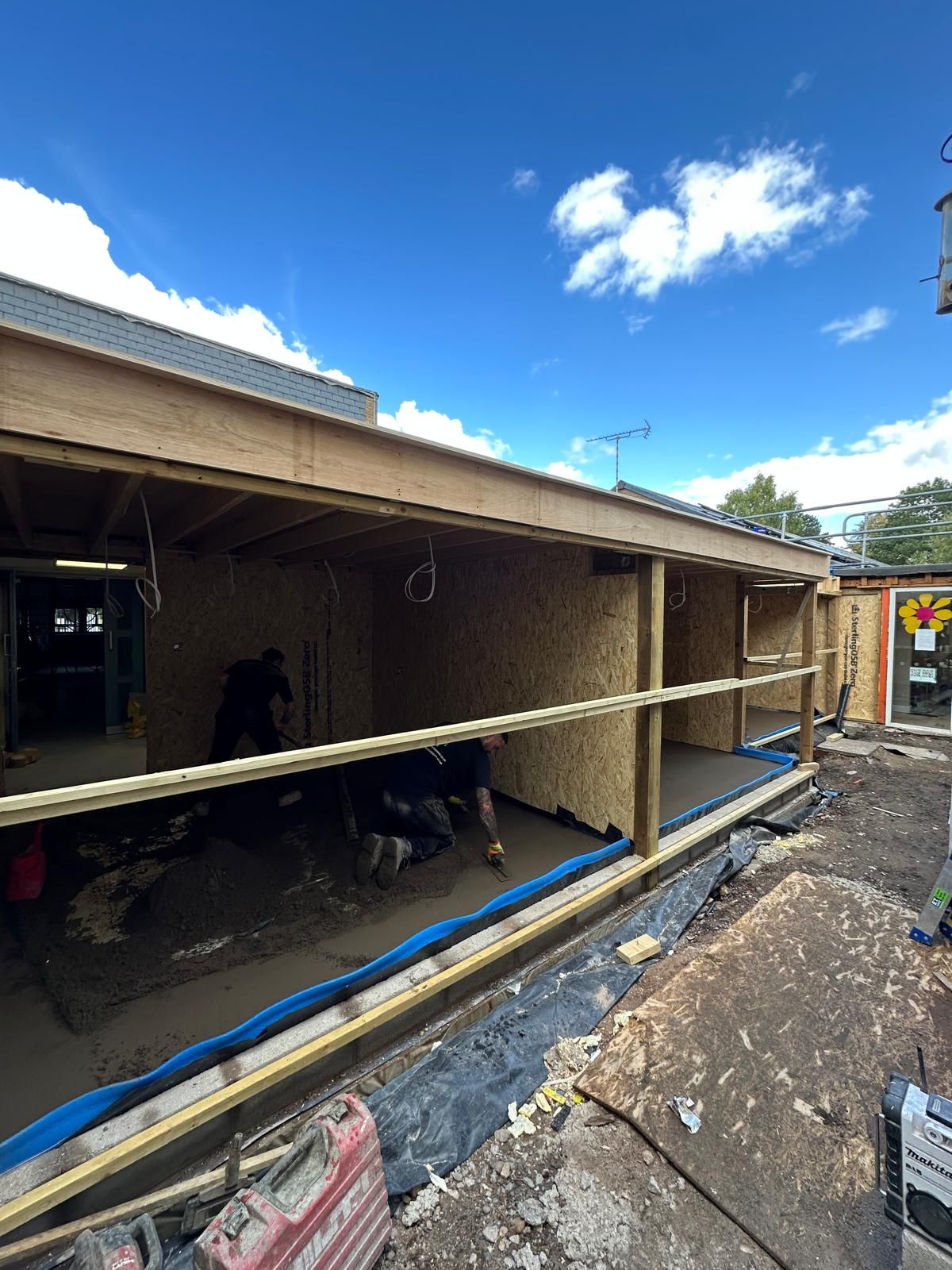 Screed spread and ruled off across the first of the two rooms
