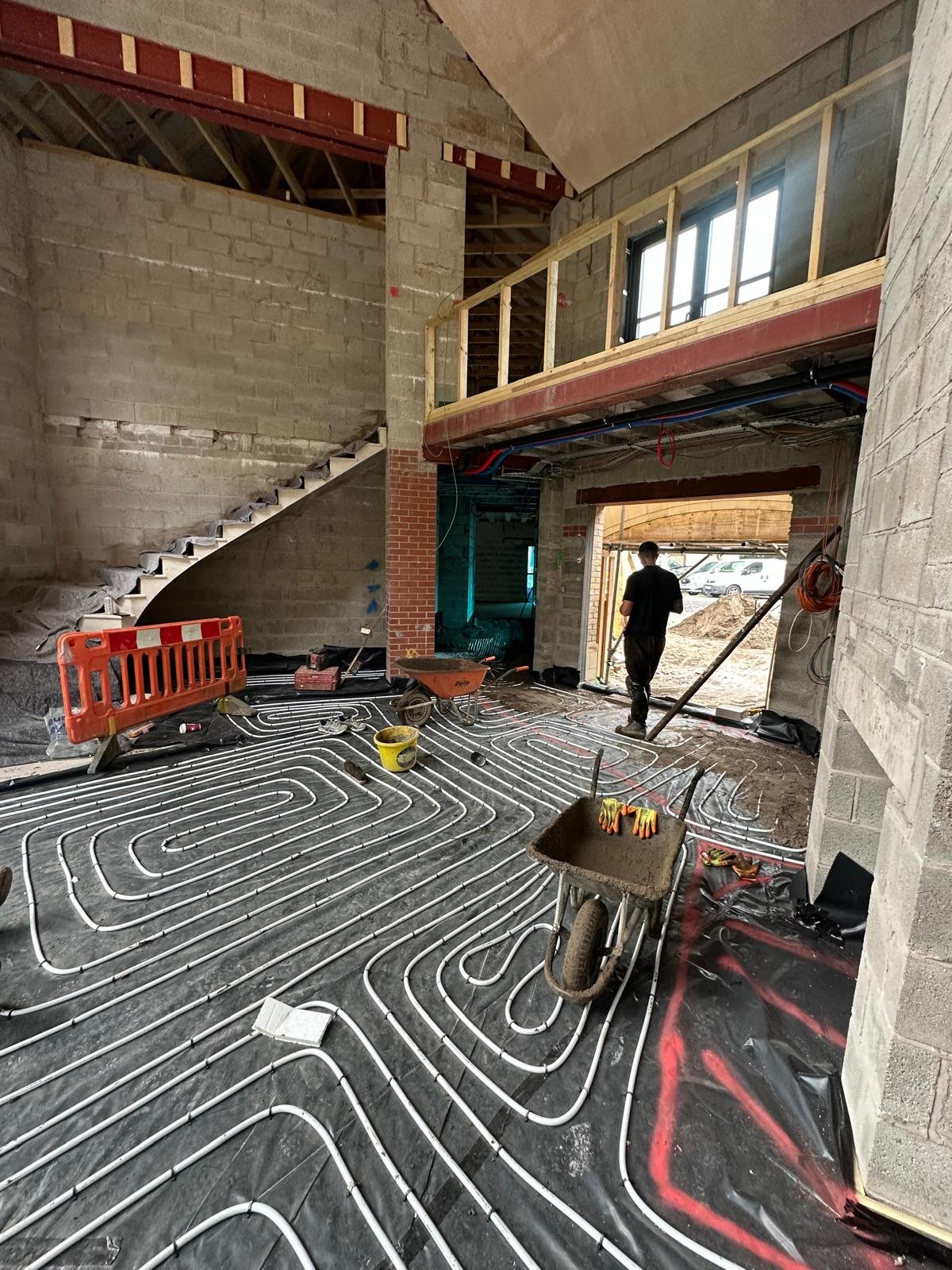 Underfloor heating pipe loops clipped down and ready for the screed pour