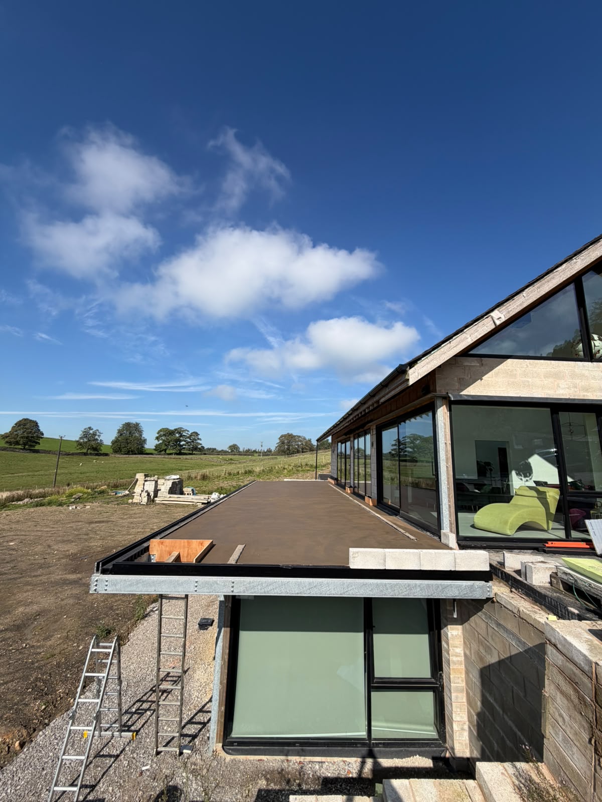 The new build at Pott Shrigley from below, with the screeded balcony deck above the lower glazing